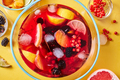 Top view on glass jug with homemade fruit berry drink with ice cubes on yellow background - PhotoDune Item for Sale