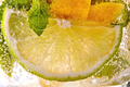 Macro photo of a summer mojito cocktail with slices of lime, lemon and mint leaves in a glass - PhotoDune Item for Sale