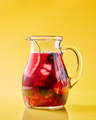Fruit berry homemade lemonade in a glass jug on a yellow background with copy space. Healthy drink - PhotoDune Item for Sale