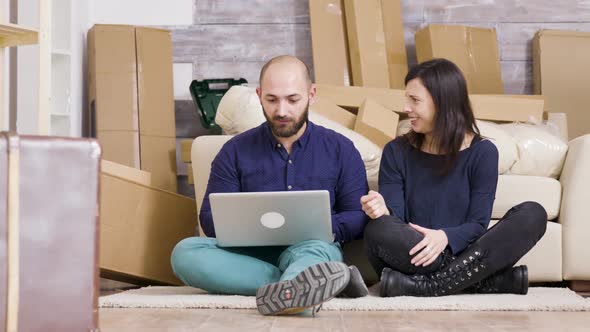 Couple in Their 30s Sitting on the Floor of Their New Flat