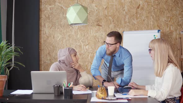 Multiethnic Male and Female Office Workers Are Brainstorming in Working Area