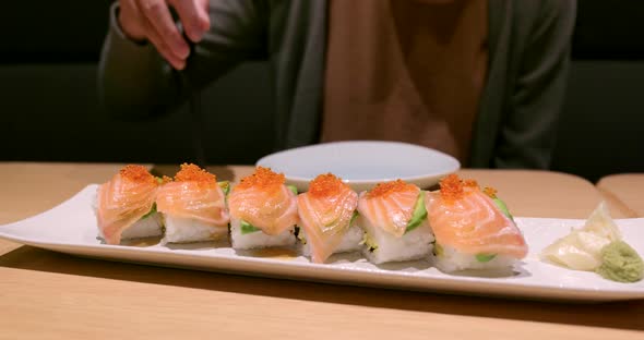 Woman enjoy the Japanese sushi in restaurant