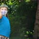 Little girl putting on a medical face mask and showing thumbs up gesture - VideoHive Item for Sale