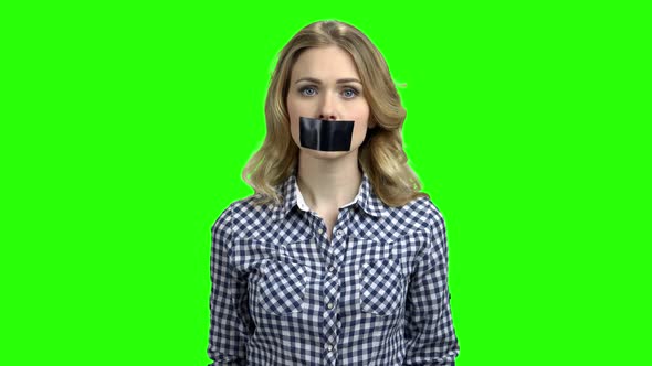 Pretty Girl with Taped Mouth on Green Screen