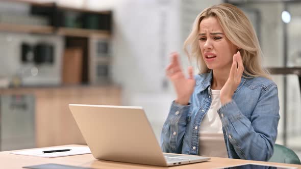 Young Casual Woman Reacting To Loss on Laptop at Work 