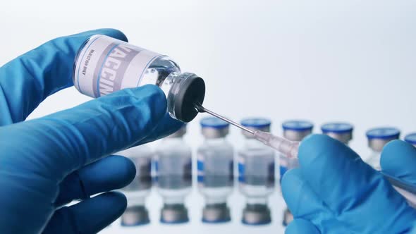 Close up, Scientist is holding a glass vial for vaccine and syringe in laboratory.