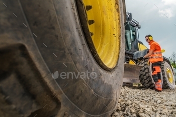 the Operator in a Background. Industrial Theme. Road Building Machine.