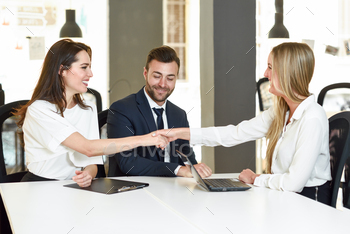 ce agent or investment adviser. Three people meeting in an office reaching an agreement