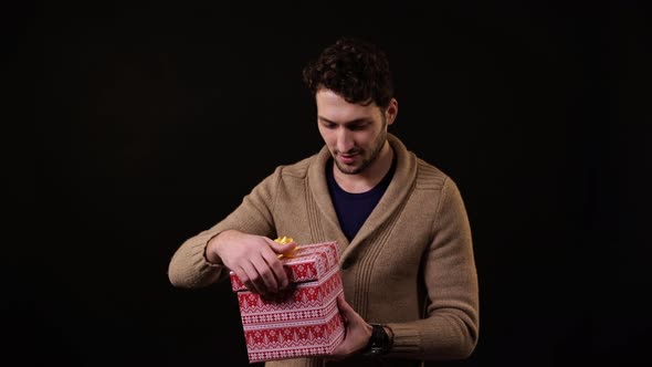 A man opening a present