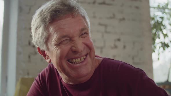 An Elderly Man is Listening His Wife and Smiling