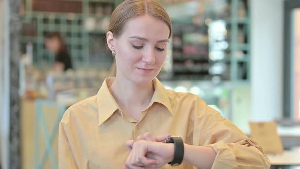 Portrait of Young Woman Using Smart Watch