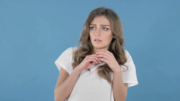 Scared Young Girl in Shock and Fear Isolated on Blue Background