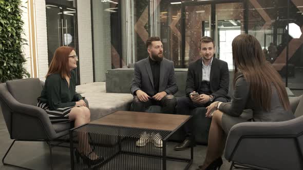 Business Team Staying Together in Conference Room and Talking About the Situation.