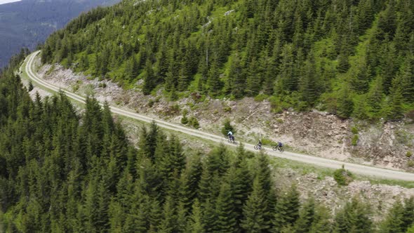 Cyclist group cycling on mountain road in Moravia, Czechia, drone shot.