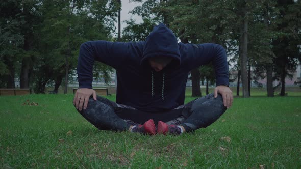Sportive man is stretching outdoors