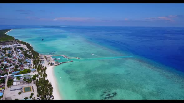 Aerial flying over landscape of marine coast beach break by transparent ocean and white sand backgro