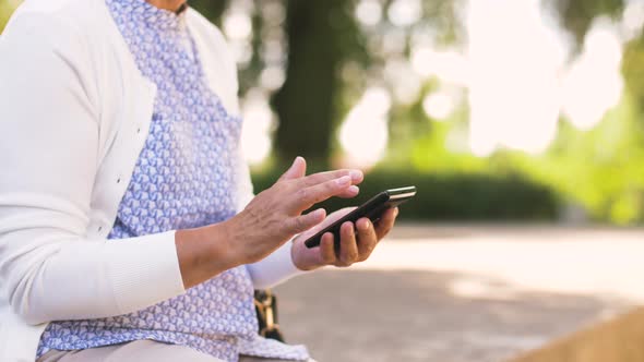 Senior Woman with Smartphone at Summer Park 30