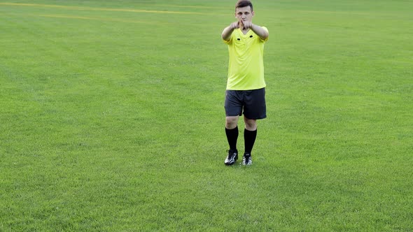 Referee goes watching VAR or violation of the rules and shows a penalty, yellow or red card
