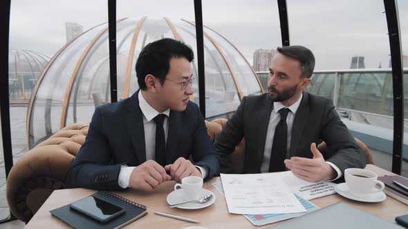 Businessmen Meeting in Rooftop Bar