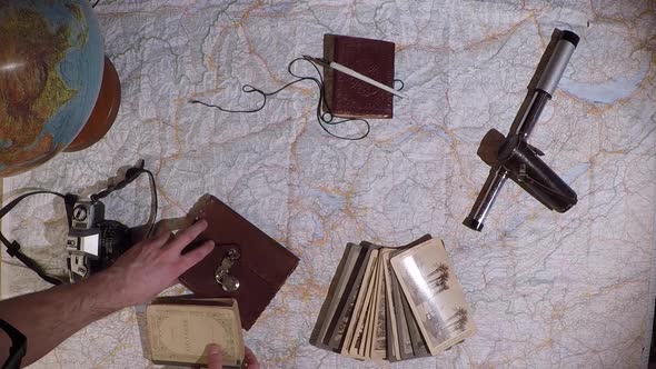 Top down traveler's map, globe and vintage accessories on top. Explorer's concept