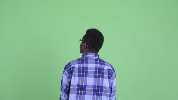 Rear View of Young African Hipster Man Pointing Finger