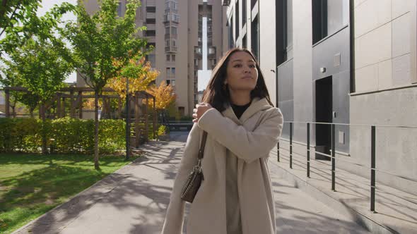 Pivoting Around a Young Adult Asian Business Woman Walking on a Sunny Autumn Day in the City