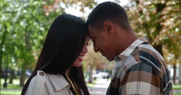 Happy Multi Ethnic Couple in Love Touching Foreheads Smiling with Closed Eyes