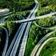 Aerial view of highway and overpass with green woods in Finland.