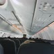 View of the Aircraft Cabin and the Back Side of the Seats with People Sitting in Them - VideoHive Item for Sale