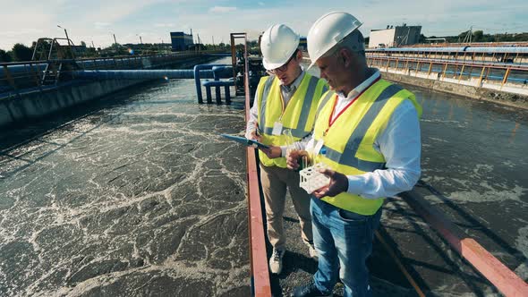 Wastewater Treatment Concept. Inspectors Are Analyzing Wastewater Probes