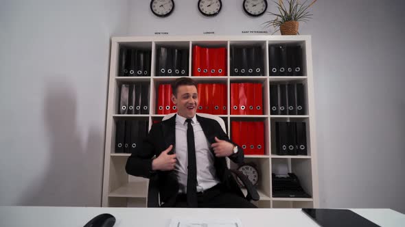 Handsome Businessman Funny Dancing in Office Armchair