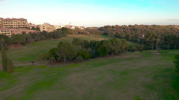 Aerial View. Empty Golf Course. Breathtaking Sunset Shining on Golf Course.