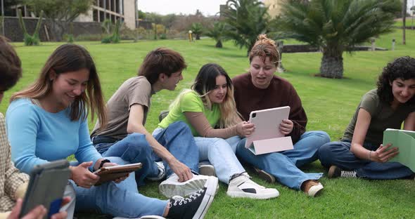 Young friends studying together outdoor sitting in university park