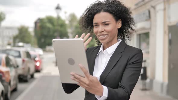 Online Video Chat on Tablet by African Businesswoman, Standing Outdoor by Road