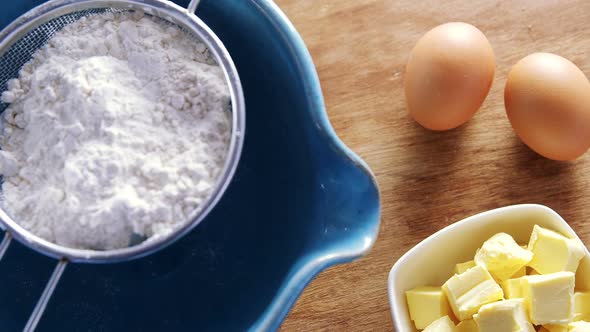 Various ingredients and brown eggs on wooden table