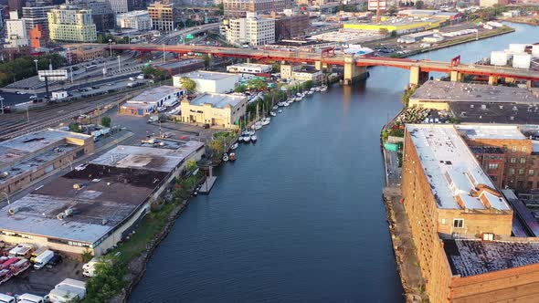 dolly shot over waterway towards the red over pass drawbridge just before sunset