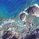 Aerial top view of waves break on rocks in a blue ocean. Sea waves on beautiful beach aerial view - VideoHive Item for Sale