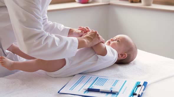 Female Pediatrician Doctor with Baby at Clinic