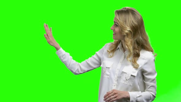 Smiling Woman Showing Something on Green Screen