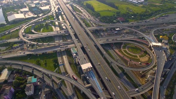 Aerial View of Highway Road Interchange with Busy Urban Traffic Speeding on Road