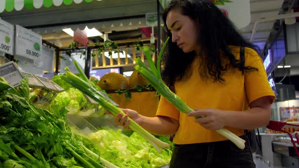 Attractive Young Woman a Chooses Cabbage Salad Makes Purchases in the Supermarket Buys Groceries