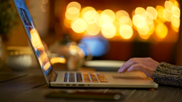 Woman Wearing Sweater, Taking a Sip of Coffee and Surfing Internet Via Her Laptop. Bright Yellow