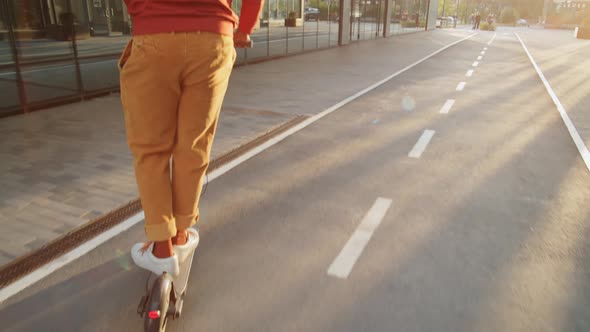 Man Riding E-Scooter in Morning