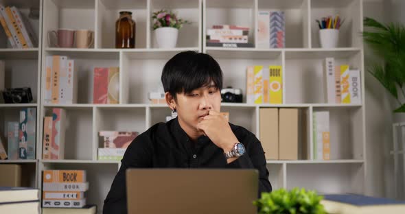 Businessman thinking and working on laptop