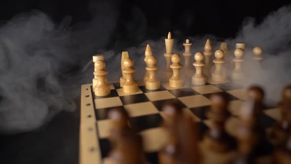 Close Up of White Chess Pieces on Board with Dissipating Steam