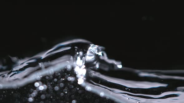 Super Slowmotion Shot of Water Wave Against Black