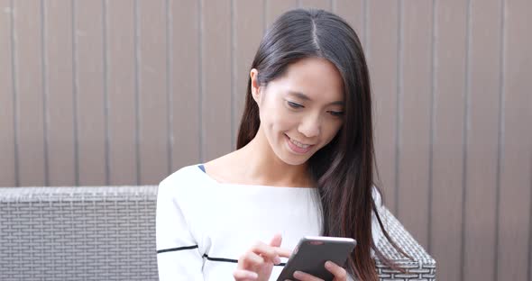 Woman use of cellphone at outdoor coffee shop