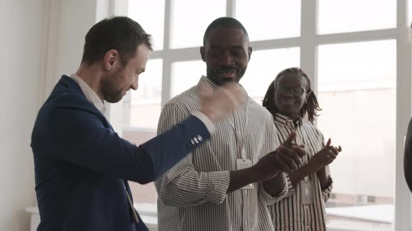 Diverse Colleagues Clapping and Shaking Hands