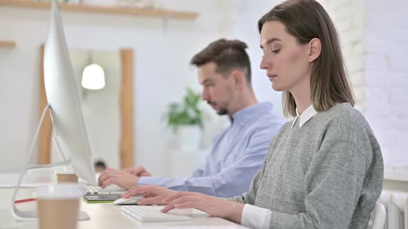Focused Creative Woman Working on Desktop in Modern Office