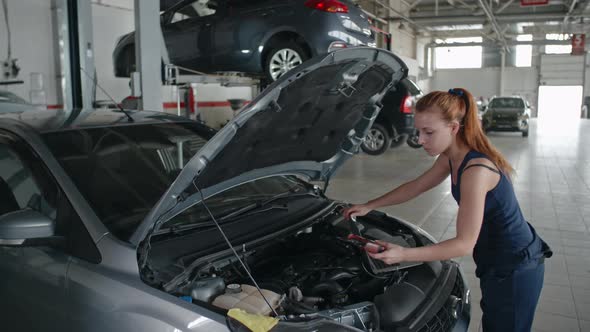 Lady Mechanic Working in Car Service alt